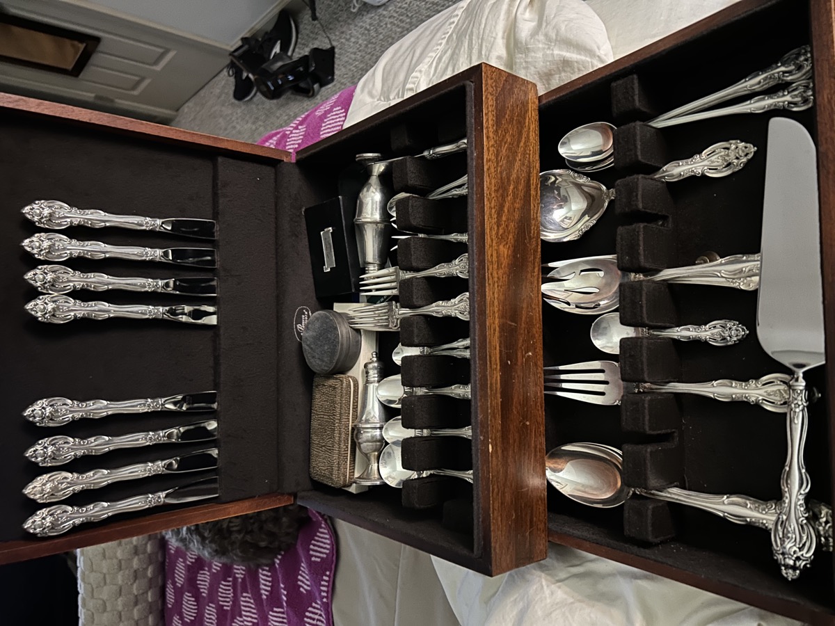 Sterling silver flatware set in display case