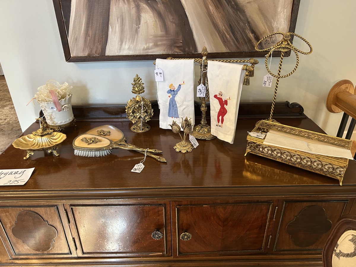 Antique brass decorative items on dresser